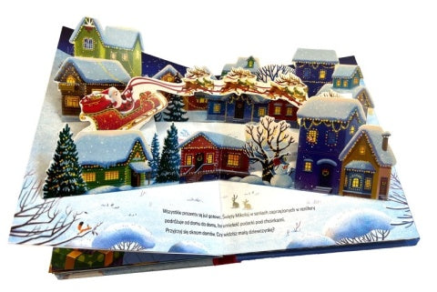 Rozkładana książka 3D z zimową wioską i saniami Mikołaja lecącymi nad domami